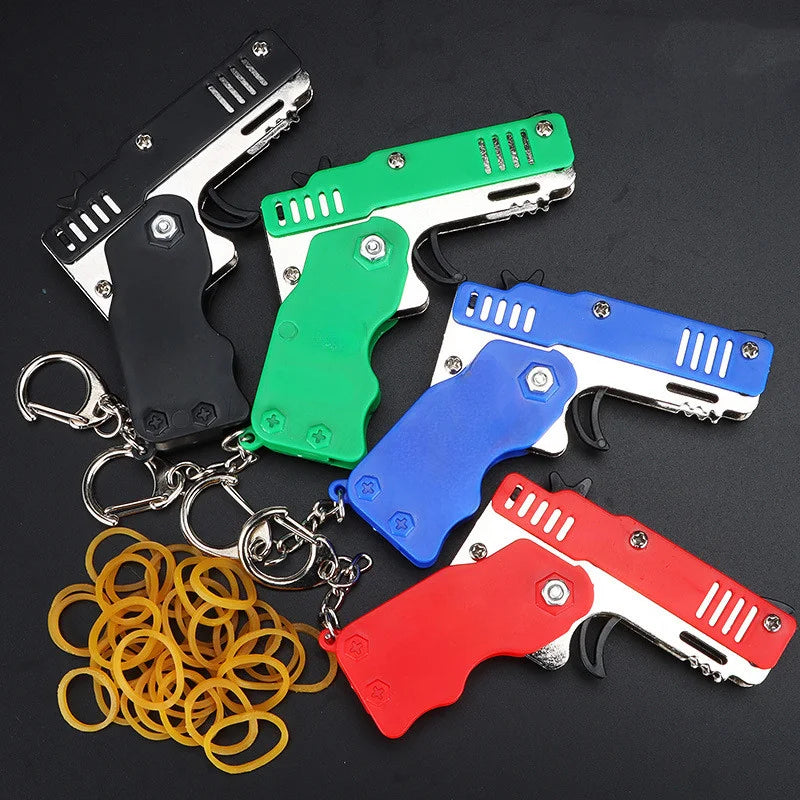 1PCS Mini Keychain Gun Rubber Band Gun Toy Shooting Pistol Alloy Kid Outdoor Party Folding Metal Gun Gifts Boyfriend Toys gift